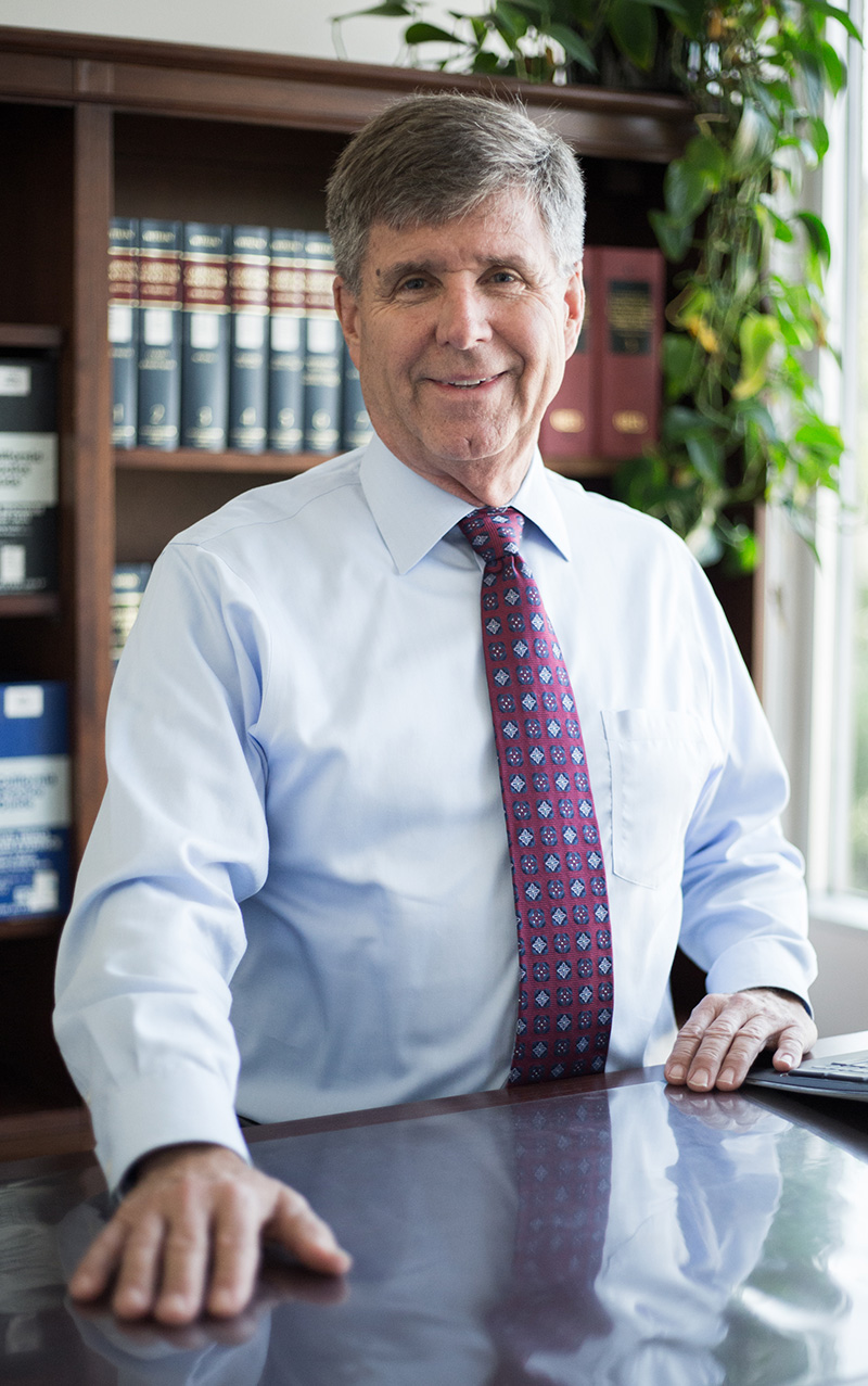 Attorney Doug Shurreen standing at his desk